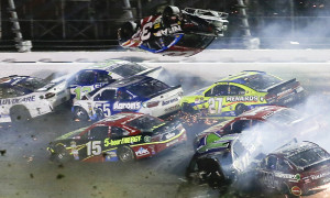 Austin Dillon (3) goes airborne and hits the catch fence as he was involved in a multi-car crash on the final lap of the NASCAR Sprint Cup series auto race at Daytona International Speedway, Monday, July 6, 2015, in Daytona Beach, Fla. (AP Photo/Terry Renna)  ORG XMIT: DBR143