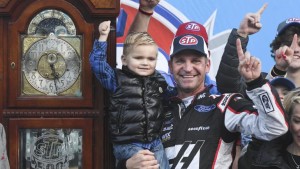 Mar 26, 2018; Martinsville, VA, USA; Monster Energy NASCAR Cup Series driver Clint Bowyer (14) and his son Cash, pose with the trophy following the STP 500 at Martinsville Speedway. Mandatory Credit: Michael Shroyer-USA TODAY Sports